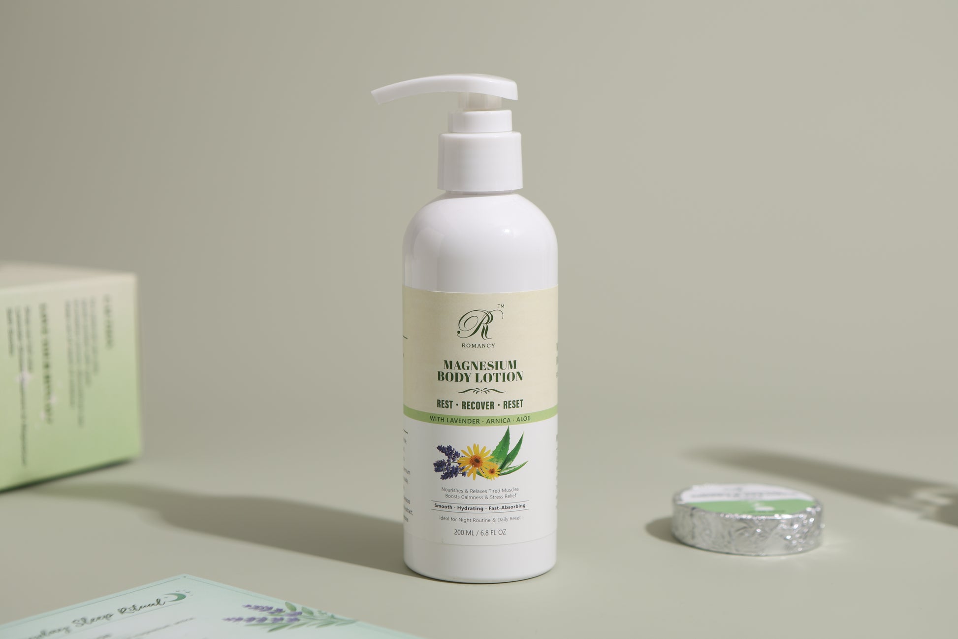 Romancy magnesium body lotion in a white pump bottle on a soft green background
