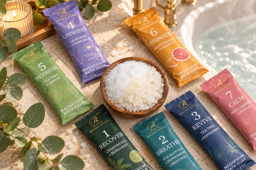 Romancy magnesium bath soak sachets arranged around a wooden bowl of bath salt by the tub